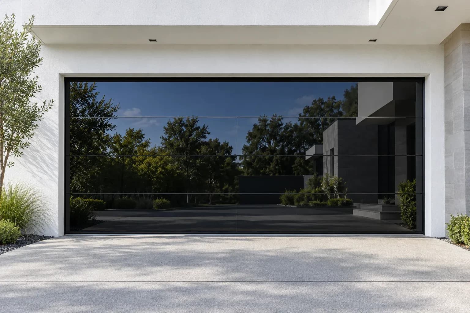 Flush black-glass garage door reflecting trees in daylight; concept image
